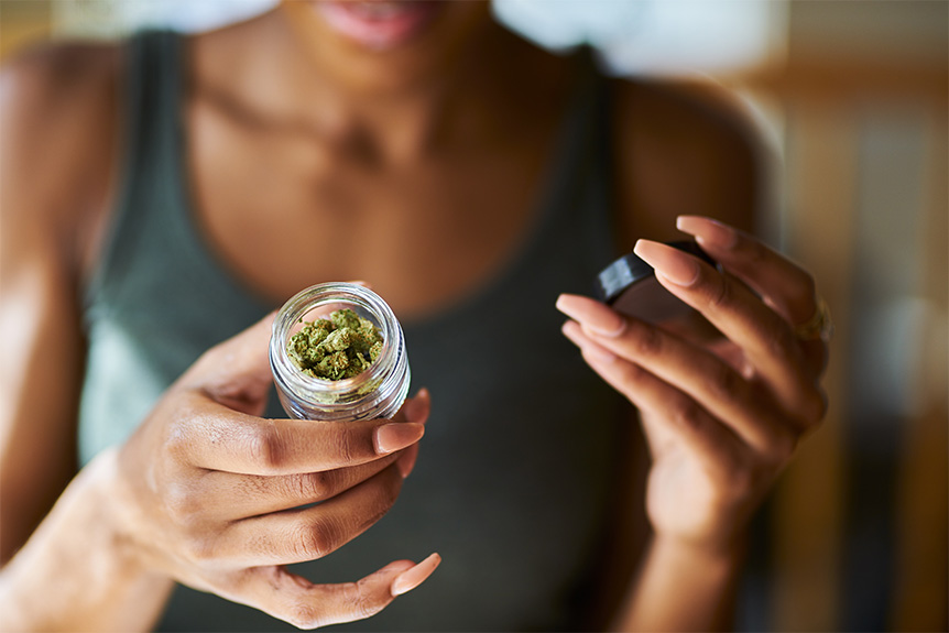 woman with jar of cannabis